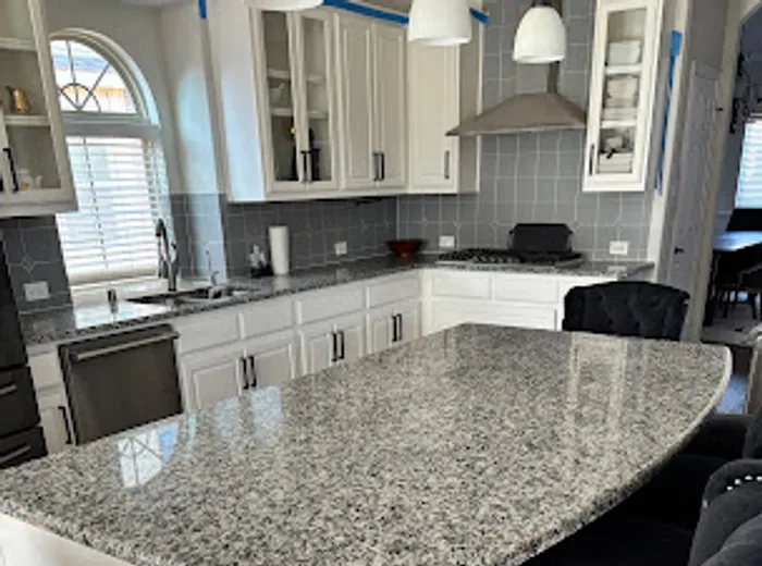 Large clean kitchen with stone island